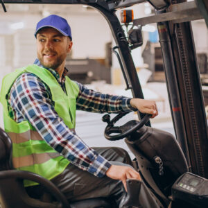 man working at warehouse and driving forklift man working at warehouse and driving forklift