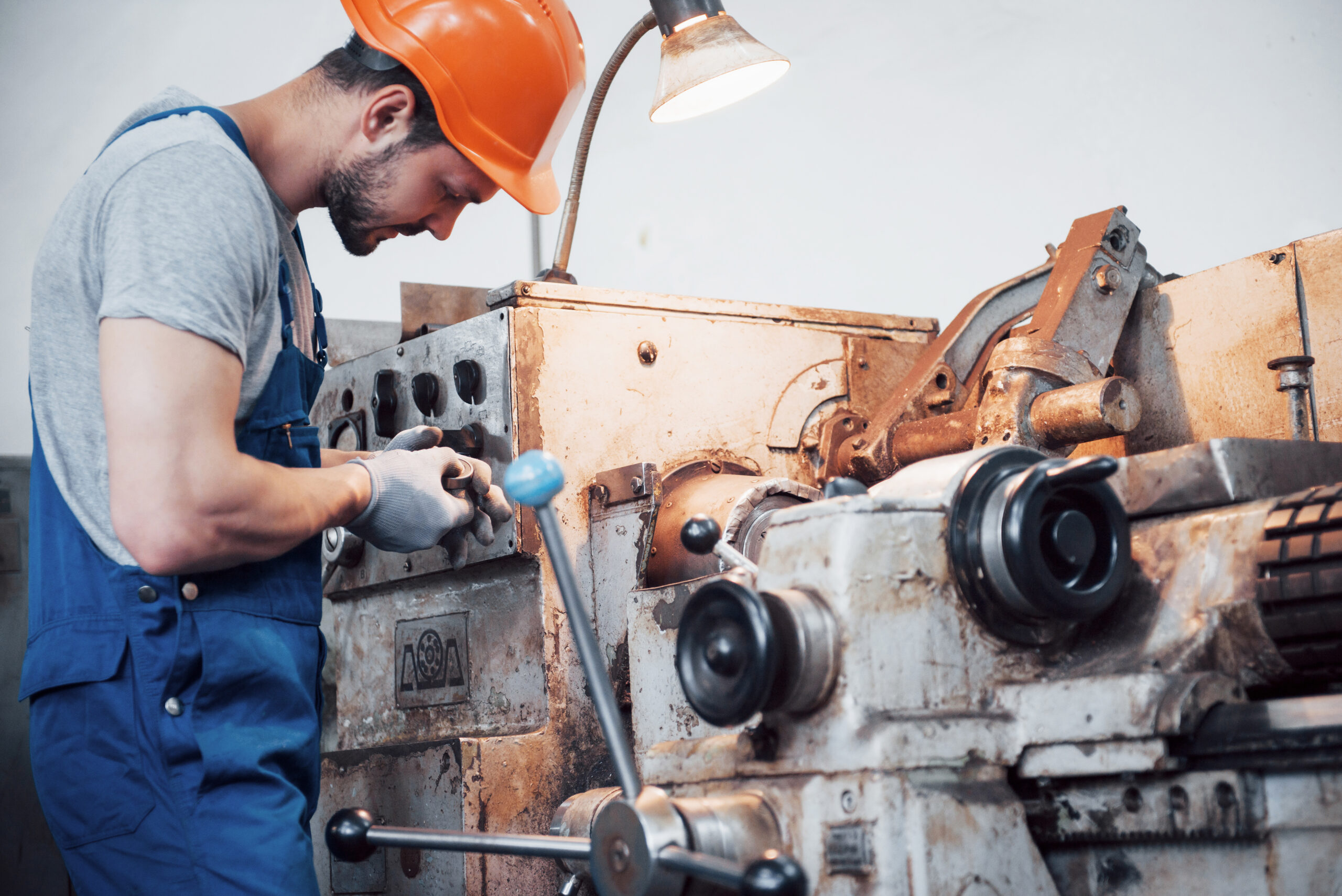portrait of a young worker in a hard hat at a large metalworking plant. the engineer serves the machines and manufactures parts for gas equipment portrait of a young worker in a hard hat at a large metalworking plant. the engineer serves the machines and manufactures parts for gas equipment